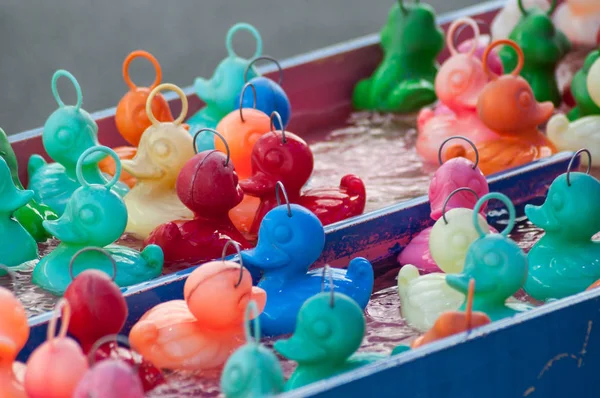 closeup of plastic rubber ducks fishing at the fun fair