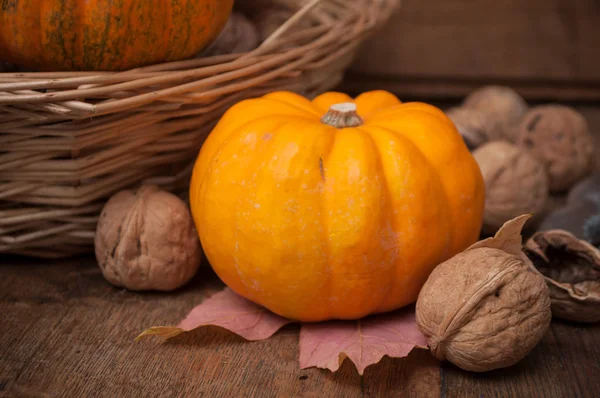 Closeup Small Pumpkins Walnuts Wooden Background — Stock Photo, Image