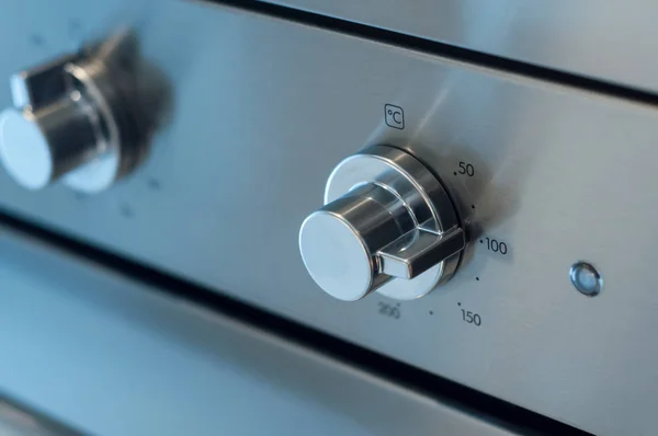 stock image closeup of oven dashboard with grey buttons