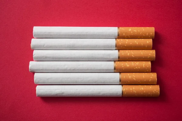Closeup Cigarettes Alignment Red Background — Stock Photo, Image