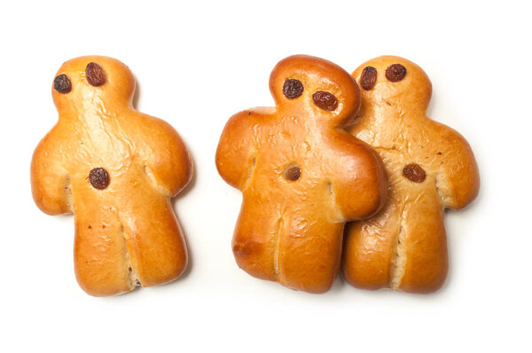 closeup of three traditional manalas bun with dried raisin on white background 