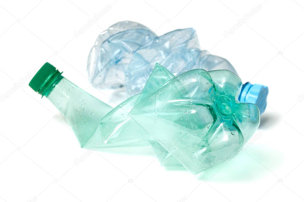 closeup of plastic bottles crushed for recycling on white background 