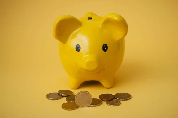 Closeup Euros Coins Front Yellow Piggy Bank Yellow Background — Stock Photo, Image