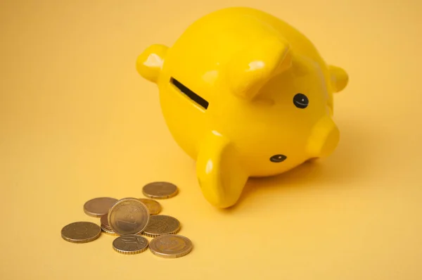 Closeup Euros Coins Front Yellow Piggy Bank Yellow Background — Stock Photo, Image