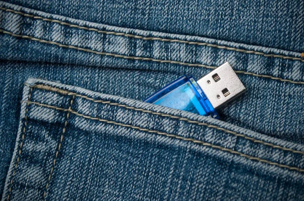 closeup of usb key storage in blue jeans pocket