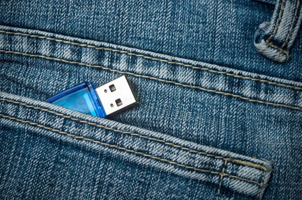 closeup of usb key storage in blue jeans pocket