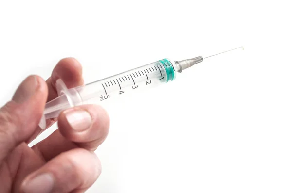 Closeup of syringe in hand on white background — Stock Photo, Image