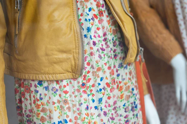 closeup of yellow leather vest and summer dress on mannequin  in