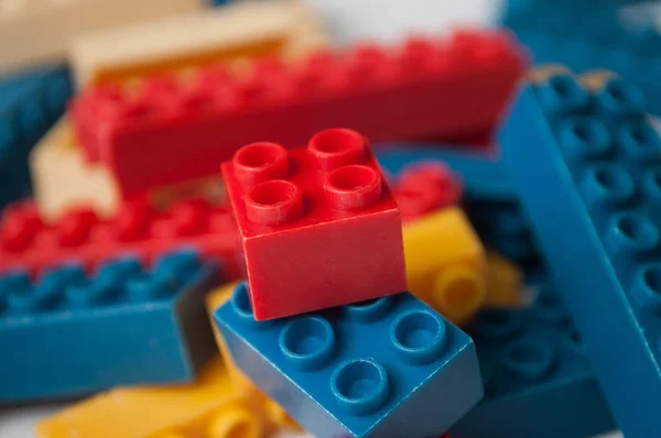 Closeup of plastic bricks construction on white background — Stock Photo, Image