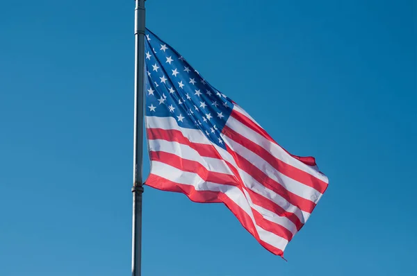 Closeup of american flag on blue sky background — Stock Photo, Image