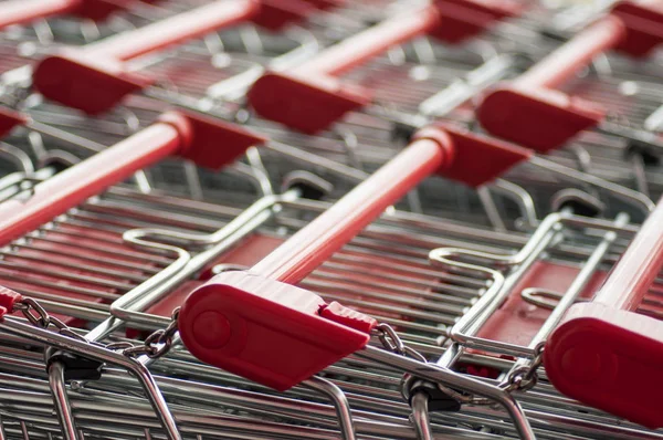 closeup of red supermarket trolleys alignment