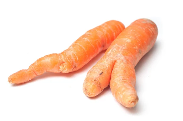 Closeup of deformed carrots on white background — Stock Photo, Image