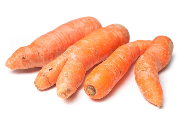 Closeup of deformed carrots on white background — Stock Photo, Image