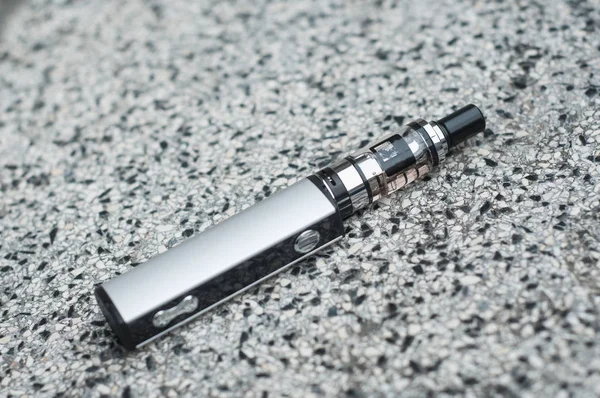 Closeup of grey electronic cigarette on stoned background — Stock Photo, Image