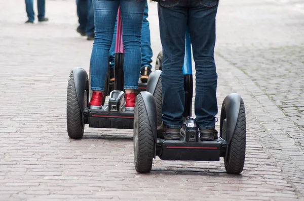 Closeup of people legs rolling on gyroboard in the street — Stock Photo, Image