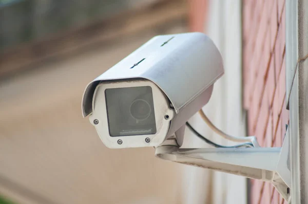 Close-up van witte beveiligingscamera op gestenigd gebouw — Stockfoto