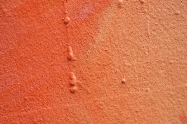 Close-up van oranje schilderij op de muur-textuur — Stockfoto