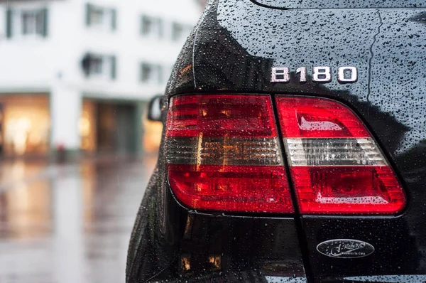 Regn droppar på svart Mercedes B180 bakljus parkerad på gatan — Stockfoto