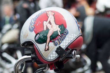 pin up painting on motorbike helmet at fun car show event clipart