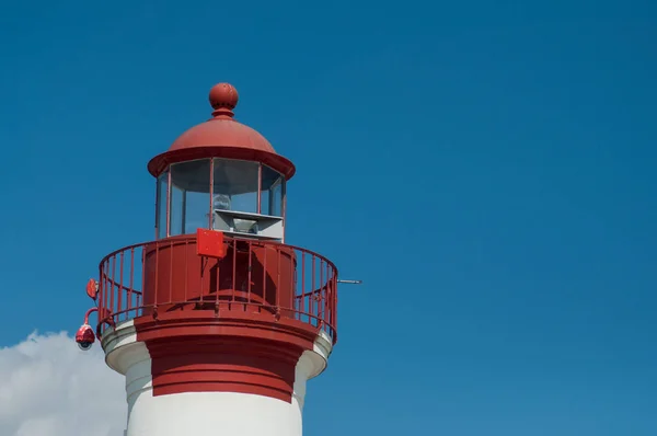 View of red lighthouse on cloudy sky background in La Rochelle Stock Image