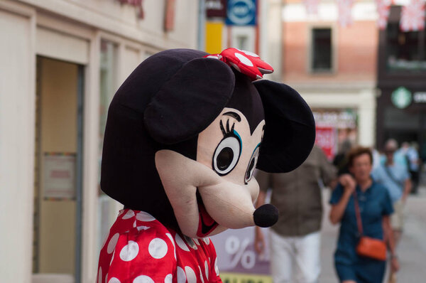 people with Minnie mouse costume in the street