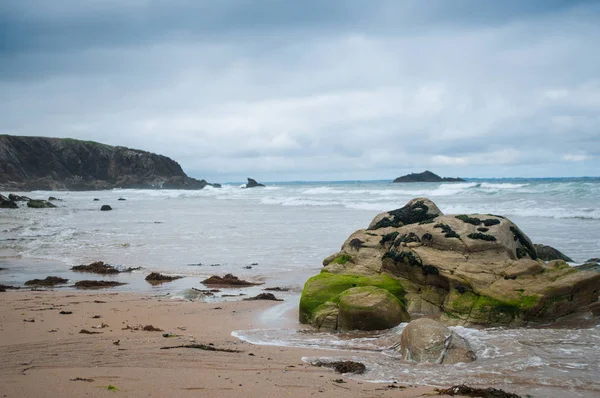 Blick auf Felsen am Strand durch schönen stürmischen Himmel Hintergrund — Stockfoto