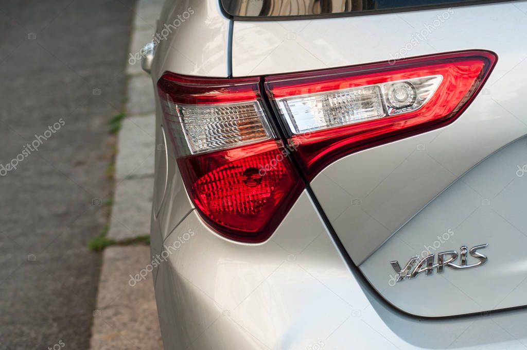 Mulhouse - France - 28 August 2019 - Closeup of rear light and sign on grey Toyota Yaris,  the famous hybrid japanese car