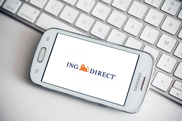 Closeup of ING Direct logo on smartphone screen from Samsung brand on white keyboard background — Stock Photo, Image