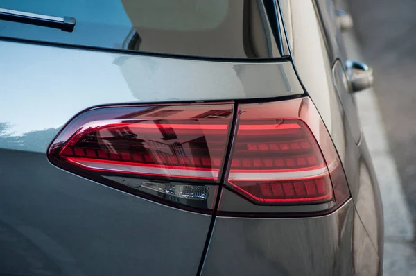 Closeup of rear light on new grew Volswagen Golf parked in the street — Stock Photo, Image