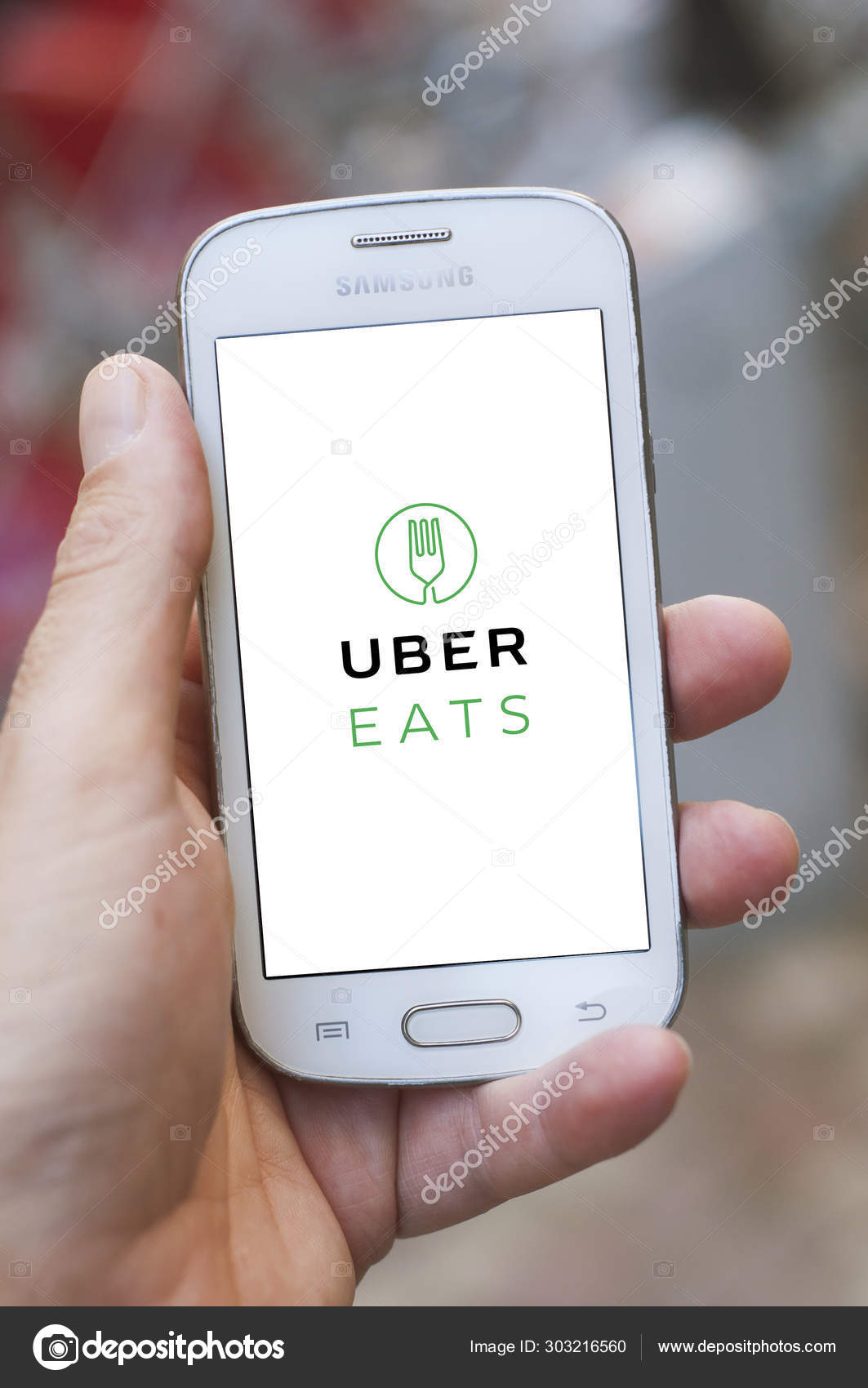 Uber Eats logo on Smartphone in hand in the street u2013 Stock 