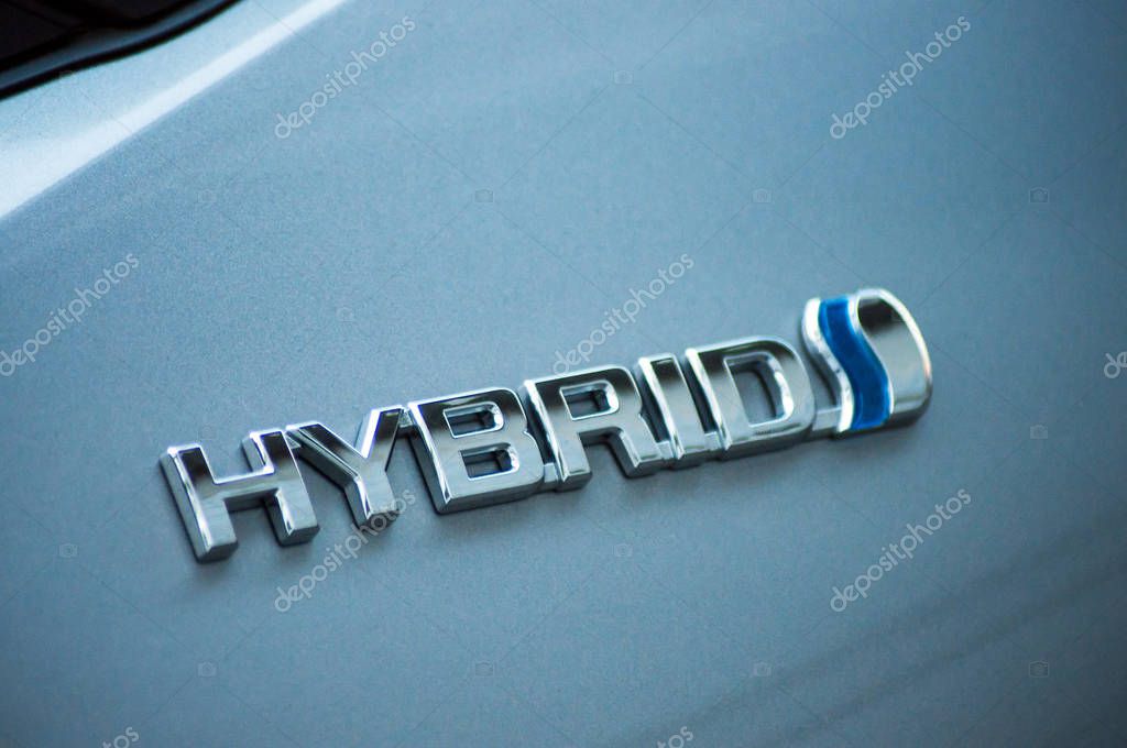 Mulhouse - France - 11 September 2019 - Closeup of Hybrid sign on blue toyota car parked in the street
