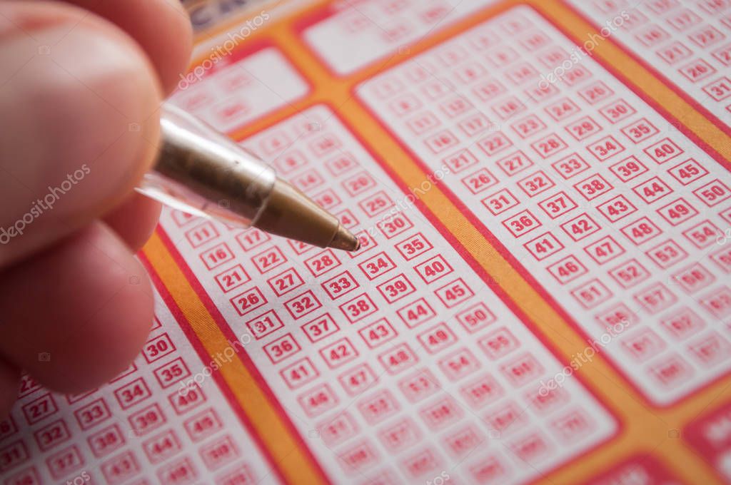 Mulhouse - France - 11 September 2019 - Closeup of man choice a number with a pen on french grids of Keno lotto from the society la francaise des jeux
