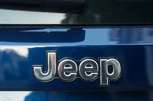 Closeup of Jeep logo on blue car rear parked in the street — Stock Photo, Image