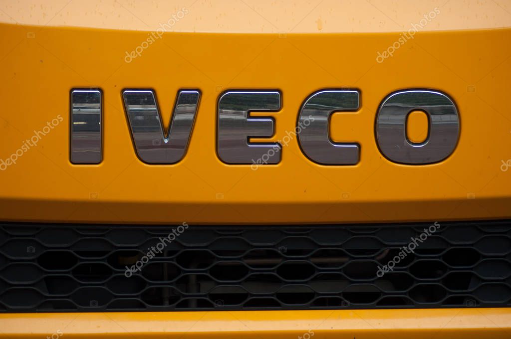 Mulhouse - France - 26 September 2019 - Closeup of Iveco logo on orange truck front parked in the street