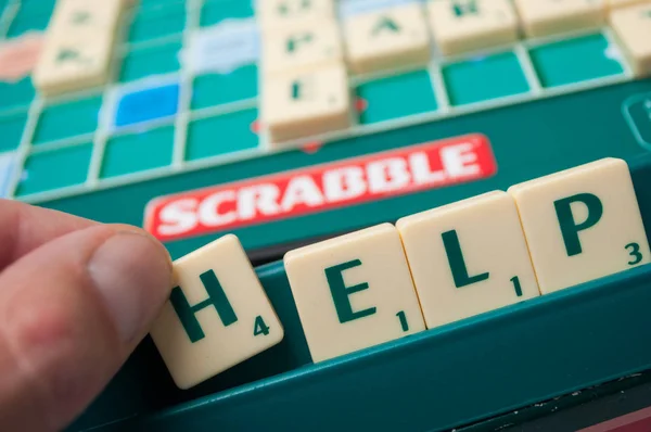 Plastic letters op scrabble bordspel vormen het woord: Help — Stockfoto