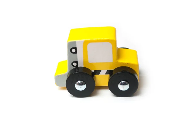 Closeup of miniature toy, wooden yellow car on white background — Stock Photo, Image