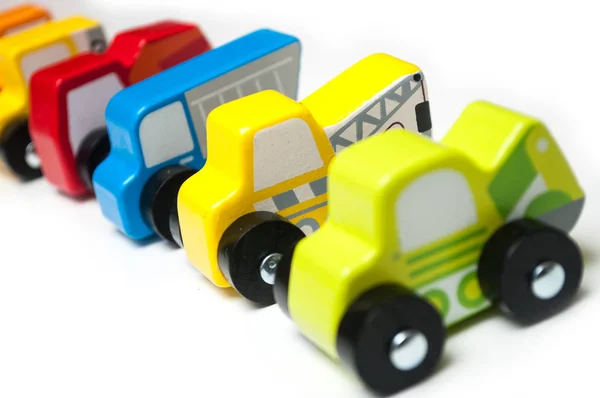 Miniature toys alignment colorful wooden cars and trucks — Stock Photo, Image