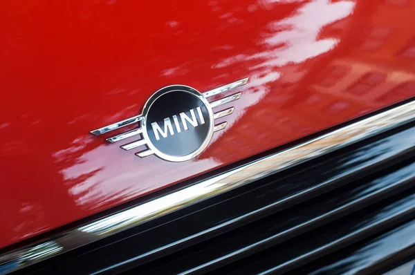 Mini cooper logo on orange car front parked in the street — Stock Photo, Image