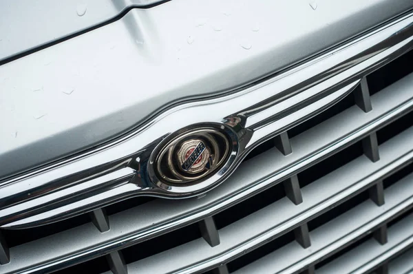 Logotipo de Chrysler en la parte delantera del coche gris estacionado en la calle — Foto de Stock