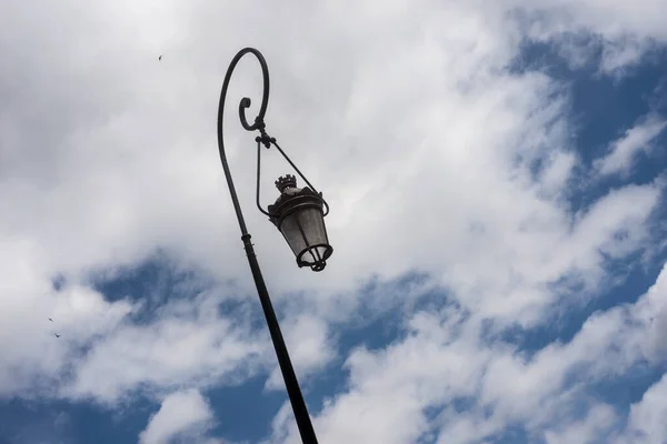 Closeup of vintage street lamp on beautiful cloudy sky background