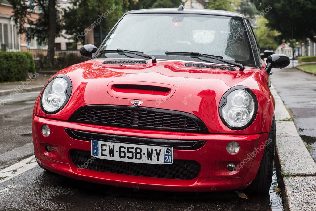Mulhouse - France - 30 August 2020 - Front view of red mini cooper S  parked in the street by rainy day