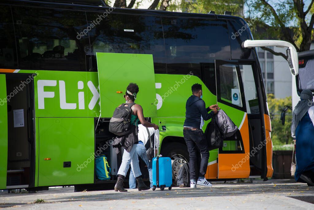 Mulhouse - France - 10 September 2020 - View of the Flixbus departure with people and suitcase in the street