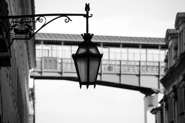 Closeup of vintage street light silhouette on the famous Eiffel elevator on background in Lisbon Portugal