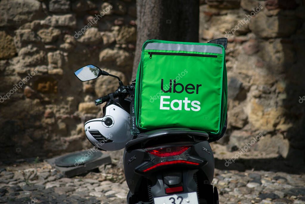 Lisbon - Portugal - 30 September 2020 - Closeup of green Uber eats delivery  bag on scooter parked in the street