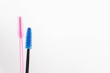 Beyaz arka planda birkaç renk kirpik fırçası. Güzellik salonu ve bakım konsepti