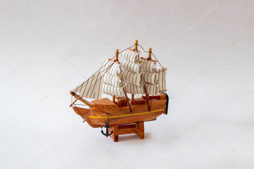 Isolated close-up of a souvenir wooden boat on a white background