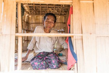 MRAUK U, RAKHINE Eyaleti / MYANMAR - 7 Aralık 2015: Yüzünde Myanmar Asia dövmesi olan yaşlı bir Chin kadınının portresi