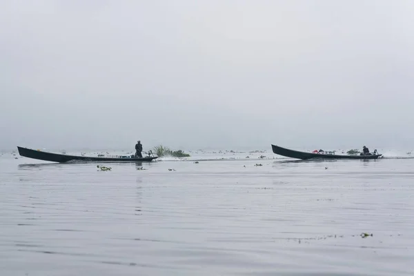 Traditional fisherman on a boat on Inle Lake Myanmar Burma in Asia