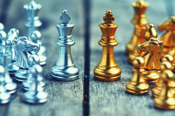 Chess board game, gold and silver team, business competitive concept