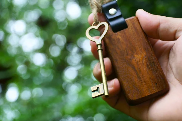 Vintage House Key Classic Wooden Home Keyring Hand Blur Green — Stock Photo, Image